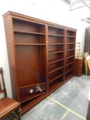 Substantial three-sectional mahogany-finish library bookcase having six adjustable shelves,