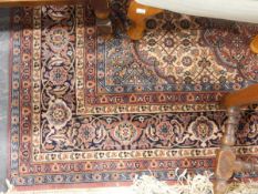Eastern-style wool rug, the pink ground with ornate central medallion and floral field,
