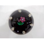 Paul Ysart glass paperweight of lampwork form, the centre decorated with a pink flower,