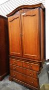 Modern reproduction linen press with moulded panel doors over three long drawers,