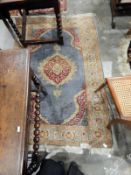 Vintage Persian-style wool rug, the blue ground with lozenge medallions, floral running border,