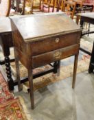 Antique oak desk with sloping lift-up top to reveal fitted interior and single frieze drawer with