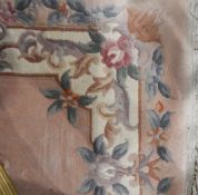 Chinese washed wool rug, rectangular, allover floral decorated to a pink ground,