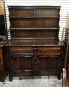 Stained oak dresser with plate rack and two long drawers, cupboard underneath,