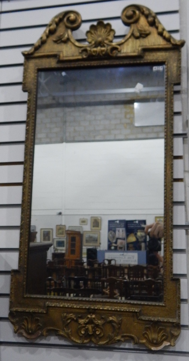 Victorian gilt mirror with scroll top and shell finial, floral skirt,