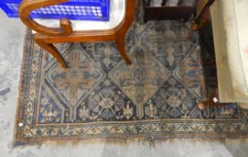 Eastern-style fine wool rug having floral and scroll shaped central medallion to a blue ground with