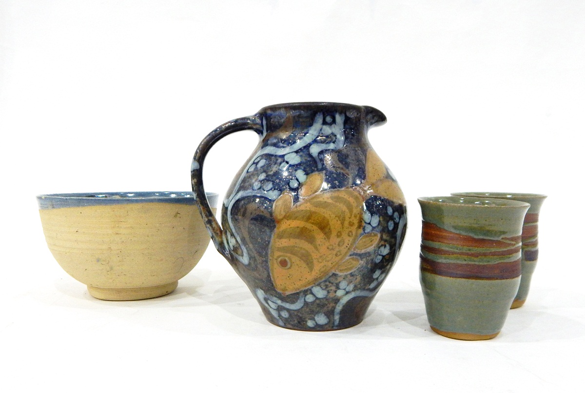 Set of studio pottery beakers decorated in green and brown glazes,