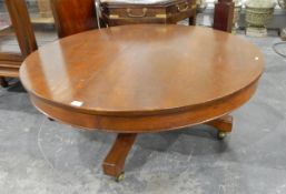 Low circular table on a low pedestal support, having quadruple swept supports,