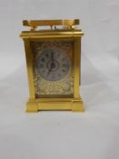 Gilt brass carriage clock with eight-day striking movement, the silver dial with Arabic numerals,