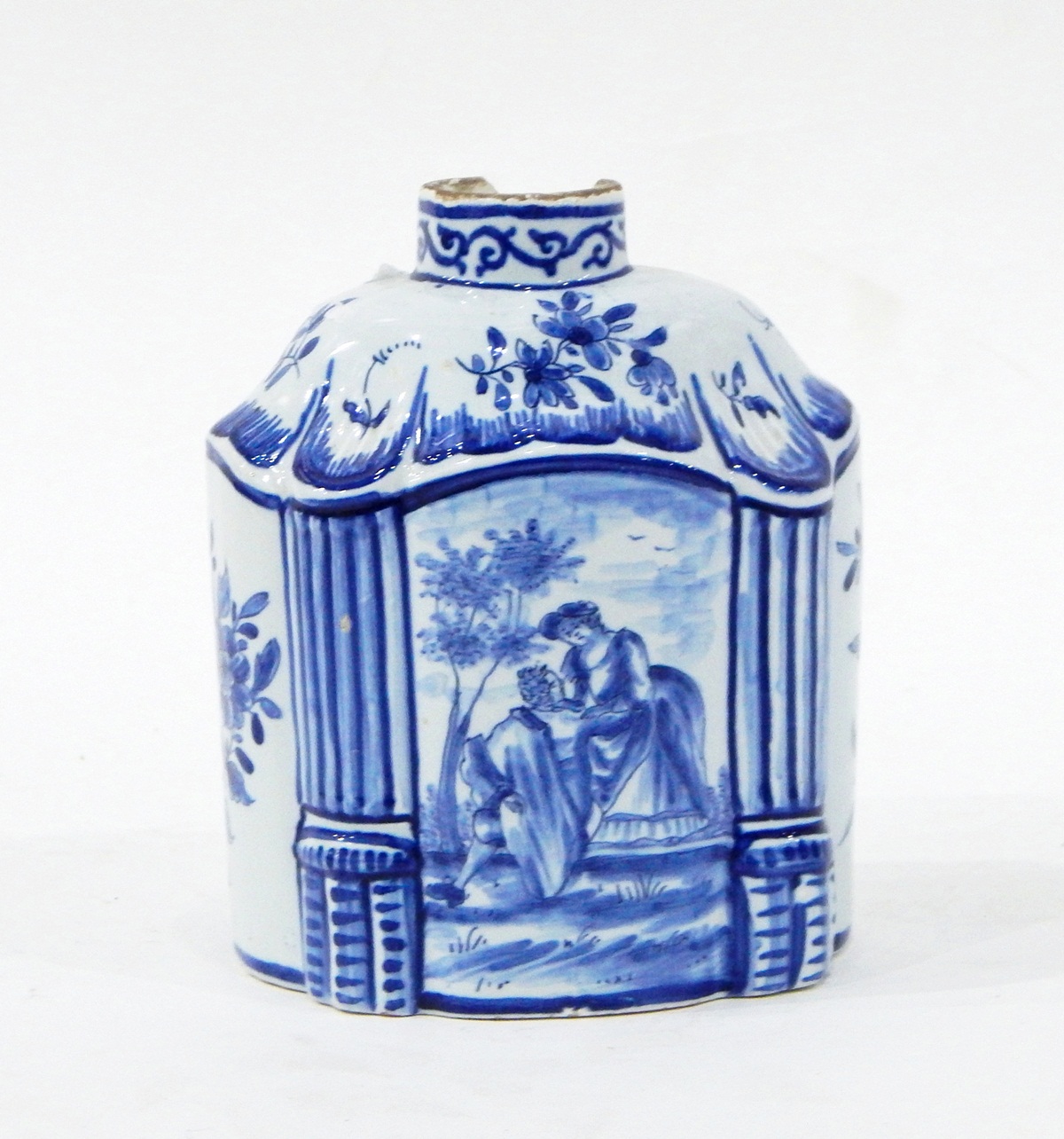 Delft blue and white tea canister of shaped oval form with central panel of an amorous couple,