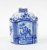 Delft blue and white tea canister of shaped oval form with central panel of an amorous couple,