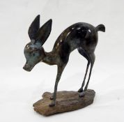 Bronze sculpture of a fawn, on stone base, 35cm high and a carved hardwood elephant,