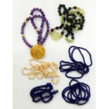 Three lapis bead necklaces, jade bead and pierced disc necklace,