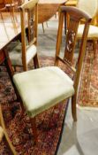 Set of four Edwardian mahogany dining chairs with satinwood stringing and shaped splats,