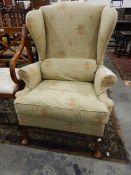 Victorian wing back chair with check and floral pattern, on cabriole supports,