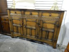 Reproduction Jacobean-style sideboard with a band of guiloche carving,