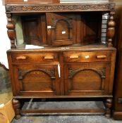 1930's oak court cupboard with two long drawers, cupboard underneath, on cup and ball supports,