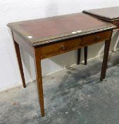 An Edwardian writing table with inset leatherette to frieze,