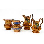 Set of three graduated copper lustre jugs with faceted bodies and painted floral decoration,