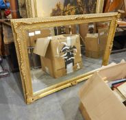 Large bevelled rectangular mirror within an elaborately carved gilt frame and a large framed print