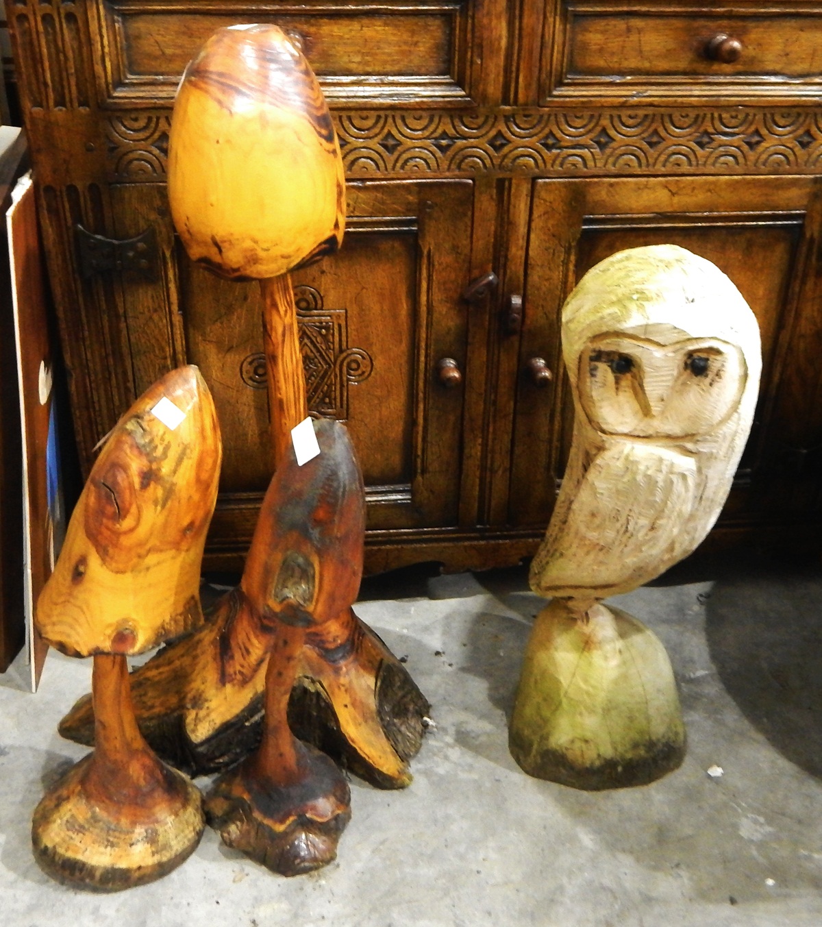 Three various carved garden mushrooms and a chain saw carved wooden owl (4)