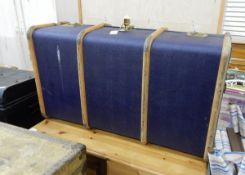 A canvas and wood bound blue school trunk,