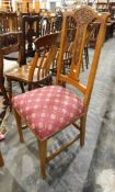 Set of four oak dining chairs with red and gold fabric seats,