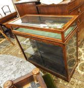 Stained oak display cabinet with lift-up top and sliding doors,