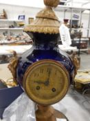 Porcelain and gilt metal clock modelled as a vase,