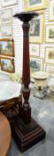 Mahogany bedpost jardiniere stand having a carved and reeded hexagonal pedestal and on a square