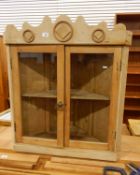 Old pine hanging corner cupboard enclosed by two glass panelled doors