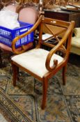 Hardwood carver's open armchair with X-frame back, shaped arms, splayed legs,