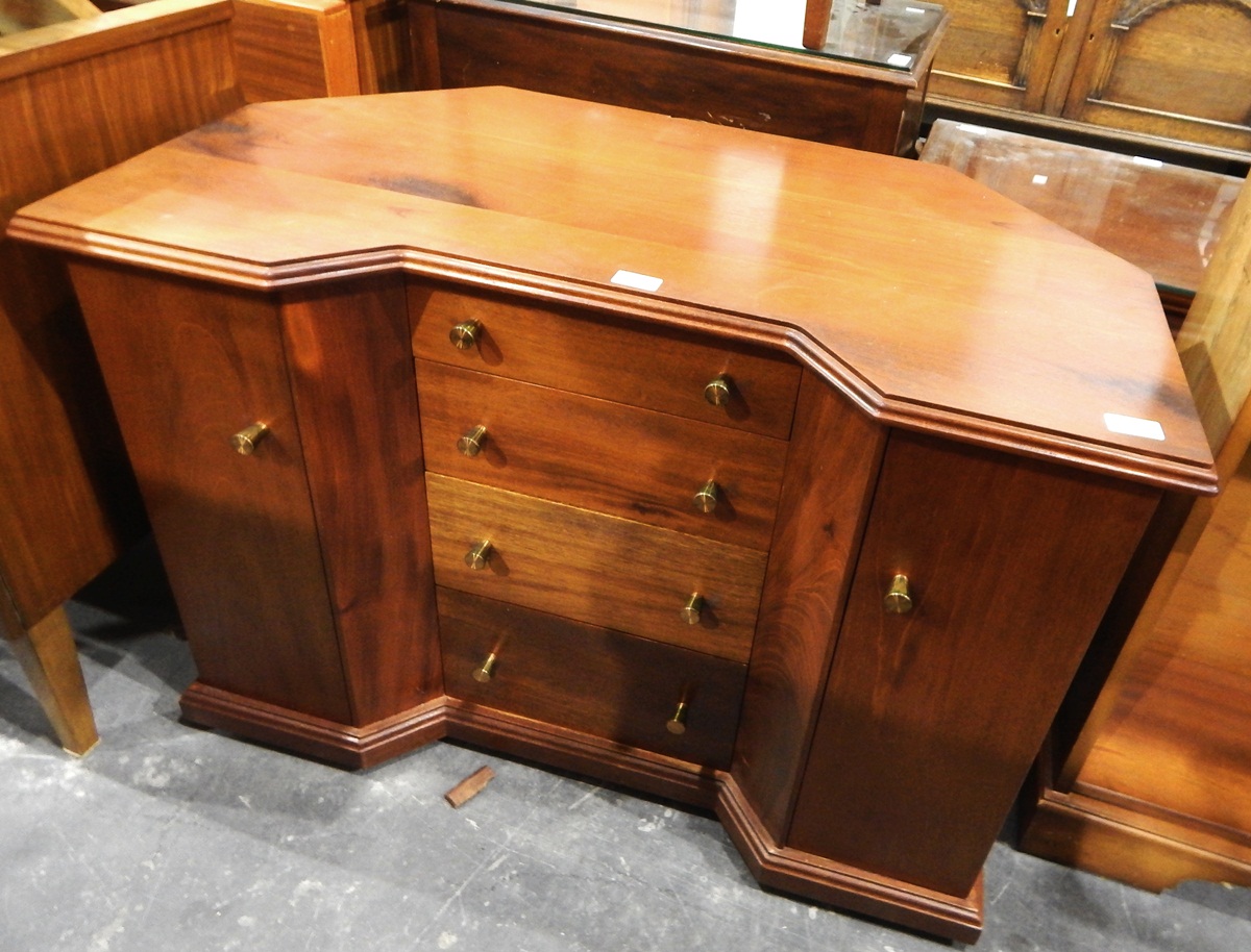 Inverted breakfront dressing table having four graduated drawers to centre flanked by two cupboards,