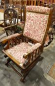 Victorian platform rocking chair with red and cream floral upholstery,