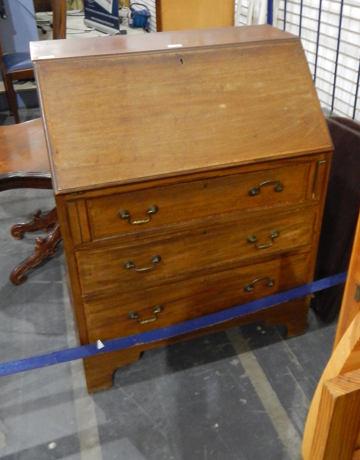 Edwardian mahogany and cross-banded bureau with the usual pigeonhole interior,