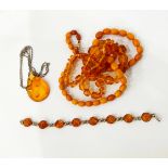 Single row of amber beads, the graduated faceted beads interspersed by disc-shaped beads,