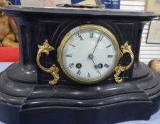 A Victorian slate mantel clock, the circular enamel dial with Roman numerals,