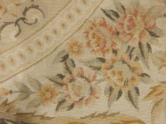 A large Aubusson style rug/wall hanging, cream ground with pale green, pinks etc.