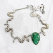 Silver necklace by Fiona Greenwood with central green hardstone pendant flanked by three serpents