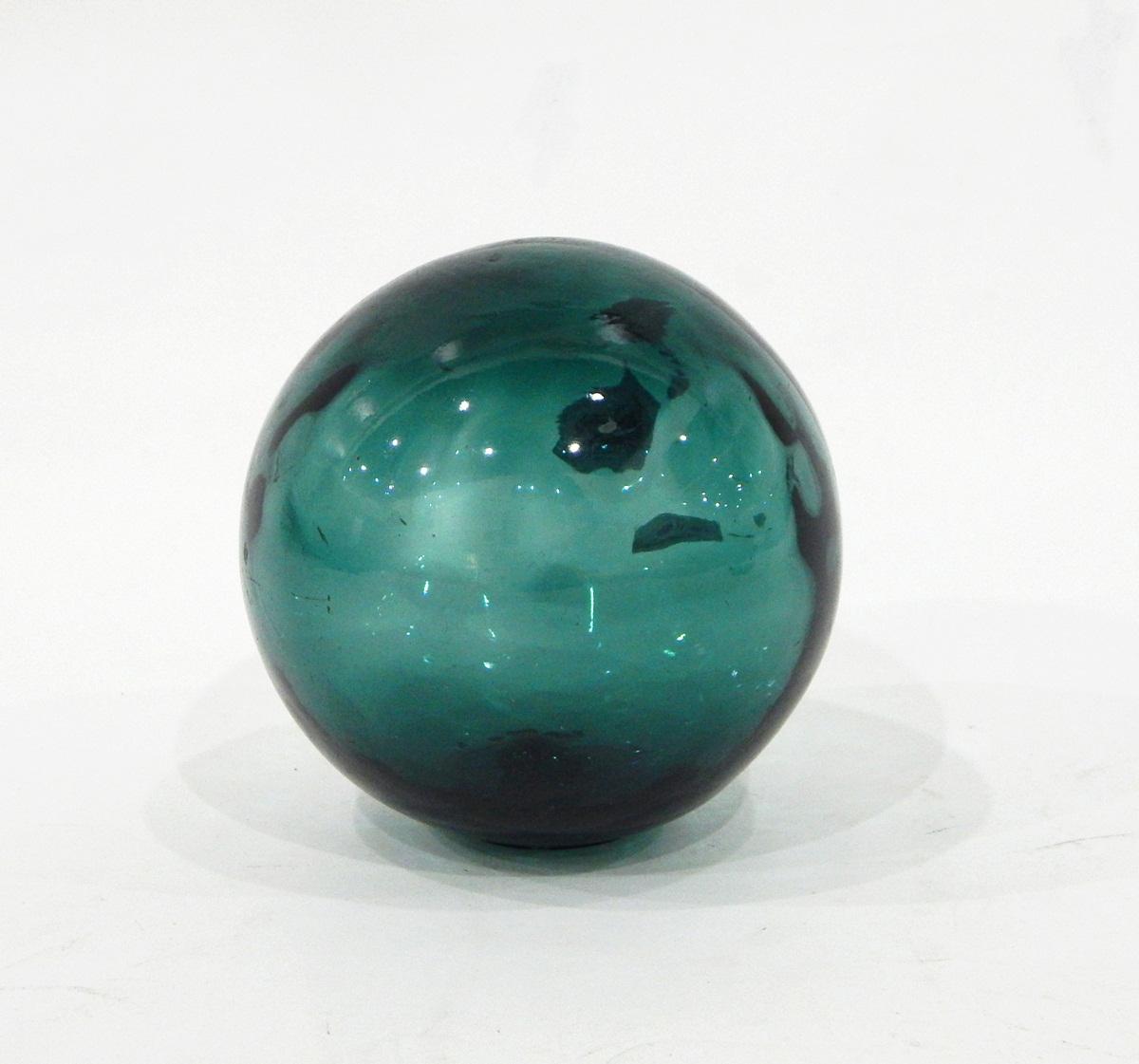 Blue glass fishing float of usual spherical form
