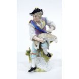 Continental porcelain figure of a man seated on a tree stump shearing sheep,