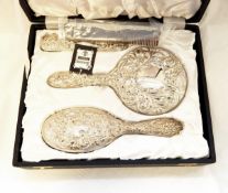 Modern silver dressing table set of four pieces, all foliate scroll decorated, viz:- mirror, brush,