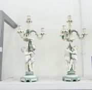 Pair of Mintons three-branch candelabra in green and white glazes with cherubs cavorting around the