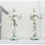 Pair of Mintons three-branch candelabra in green and white glazes with cherubs cavorting around the