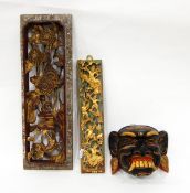 Carved wooden panel of a bird and chrysanthemum heads with gilded decoration, another of figures,