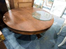 Circular topped coffee table on pedestal support and castors,