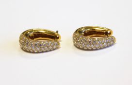 Pair 18ct gold and diamond earrings, each oval hoop,