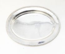 Silver oval waiter with gadrooned border,