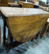 Oak oval fall-flap dining table on turned supports, 90cm wide, a stained wood bedside cabinet,