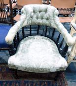 Ebonised and upholstered captain's chair with green floral fabric,